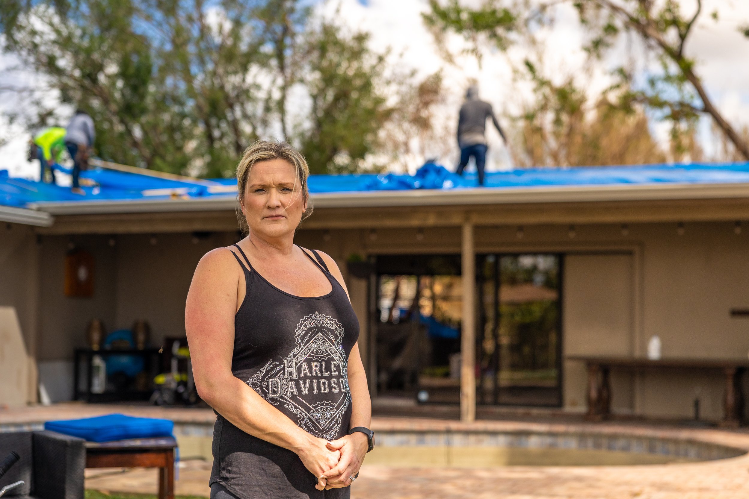 Portrait of woman in her back yard after Hurricane Ian damage in Fort Lauderdale, Florida