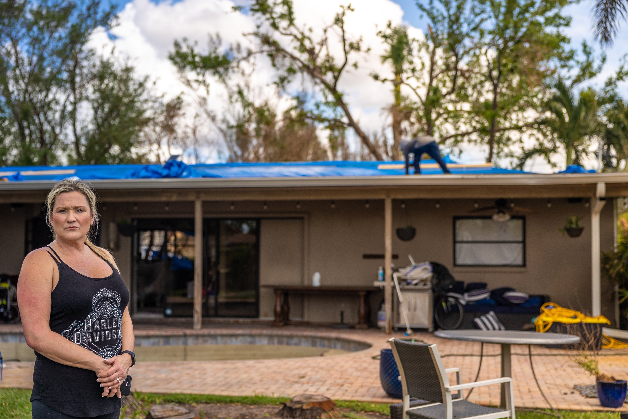 Portrait of woman in her back yard after Hurricane Ian damage in Fort Lauderdale, Florida