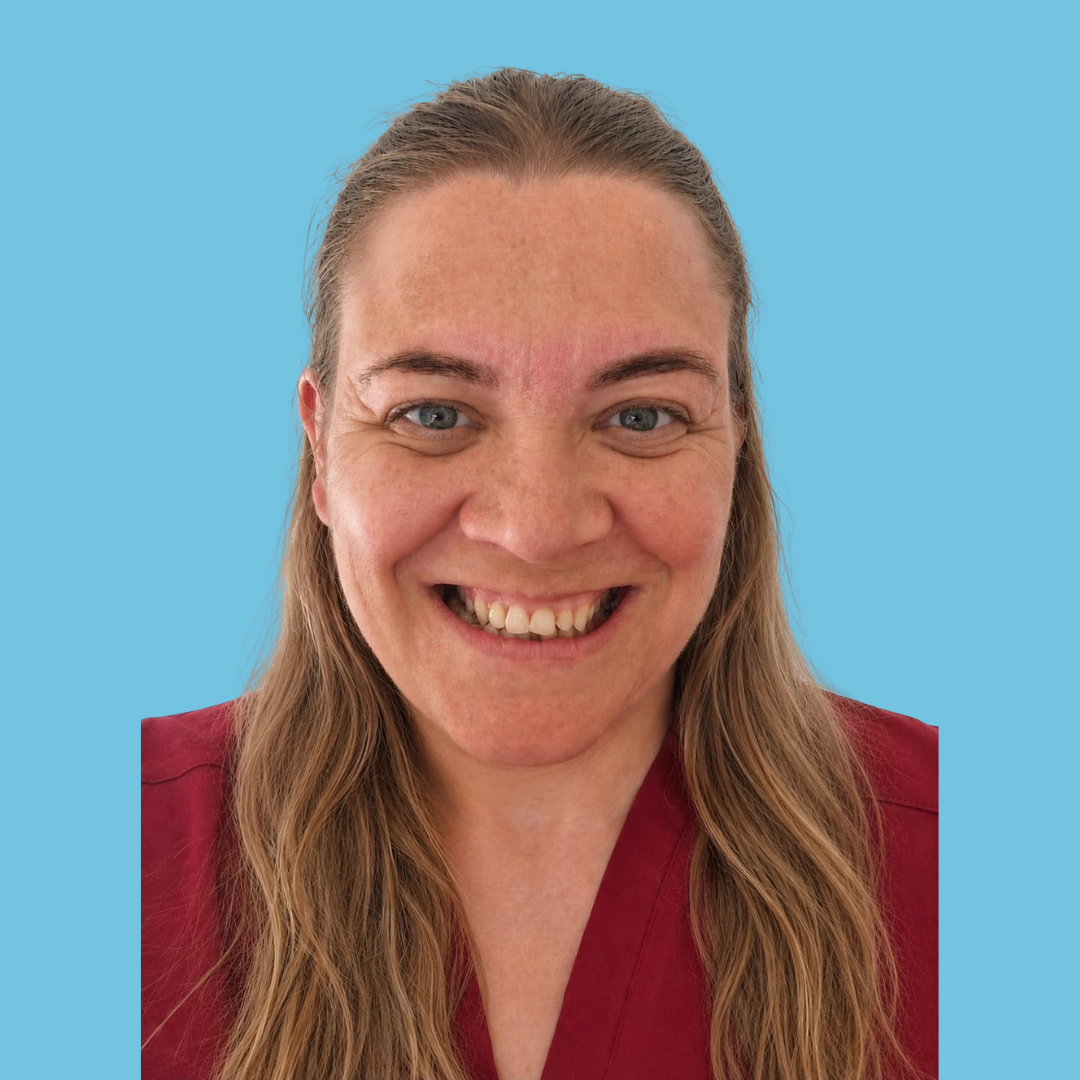 A woman with long blonde hair smiling, wearing a maroon top with lace sleeves, set against a light blue background.