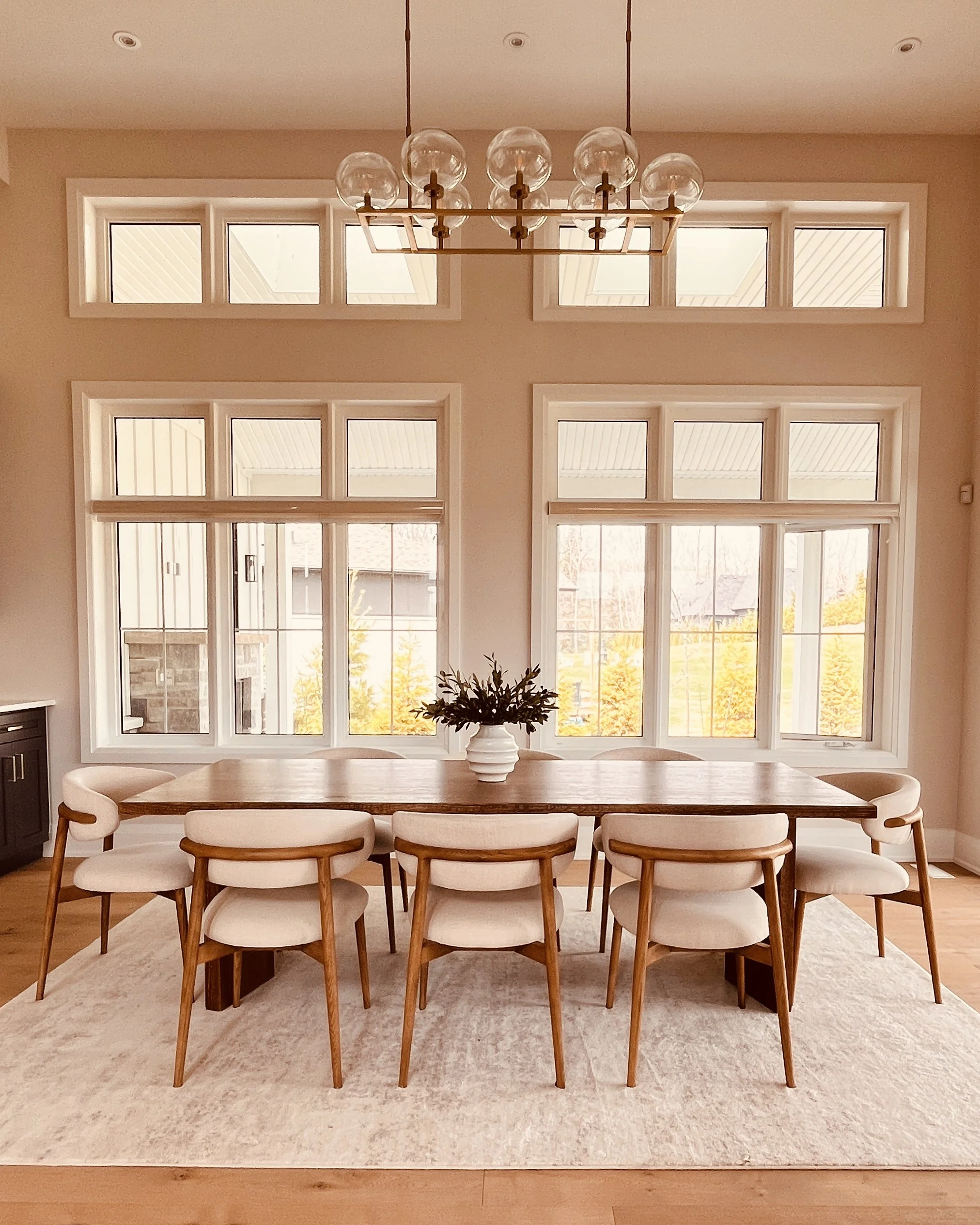 Elegant dining room with warm woods and neutral accents, staged by a Toronto home staging expert, featuring modern décor and a warm, inviting atmosphere for a luxury home.