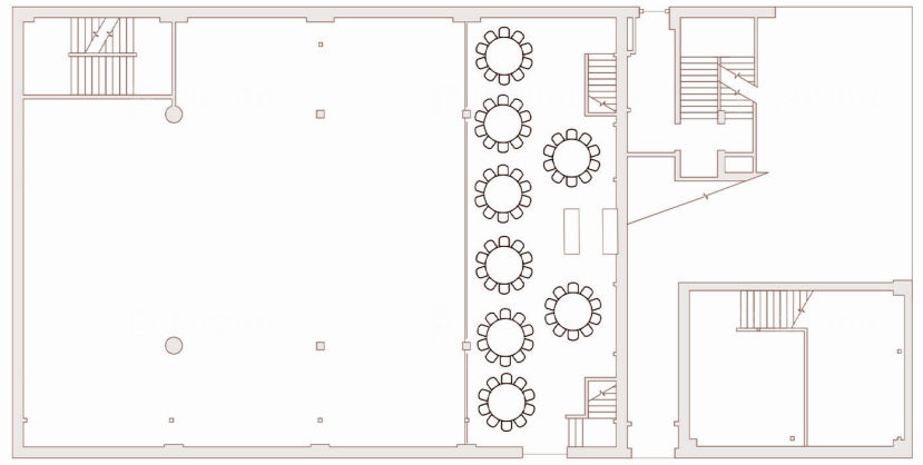 Floor plan of an indoor space with several round tables arranged in a row, likely a dining or meeting area, along with staircases and walls.