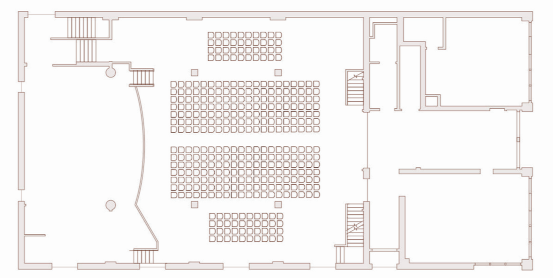 Floor plan layout of a large room with rows of chairs arranged for an event, with stages on the left side and multiple staircases.