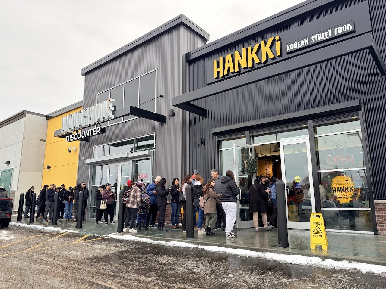 Hankki Forest Lawn location in Calgary with customers lined up outside, known for friendly service and affordable Korean street food in the Forest Lawn community