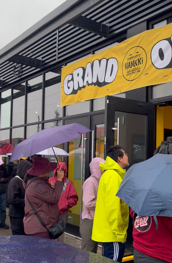 Customers lining up in the rain for the HANKKi Highfield grand opening in Calgary