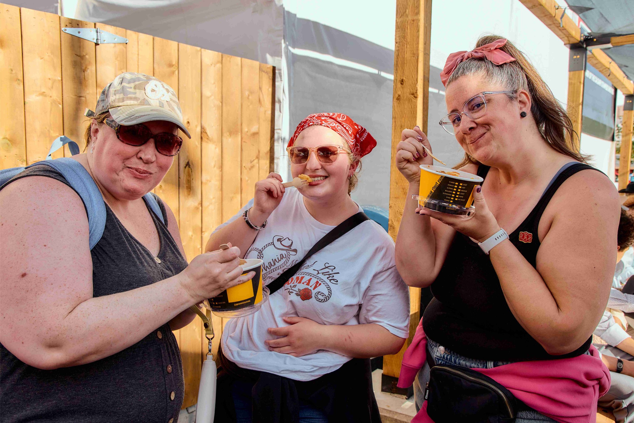 Customers enjoying HANKKi Korean street food at Calgary Stampede