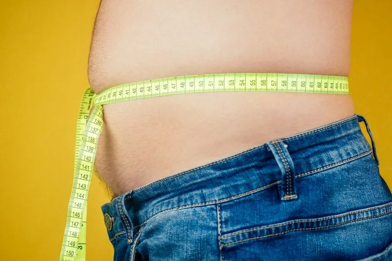Measuring waistline to show why choosing balanced fast food like HANKKi’s rice bowl can support a healthier lifestyle in Calgary.