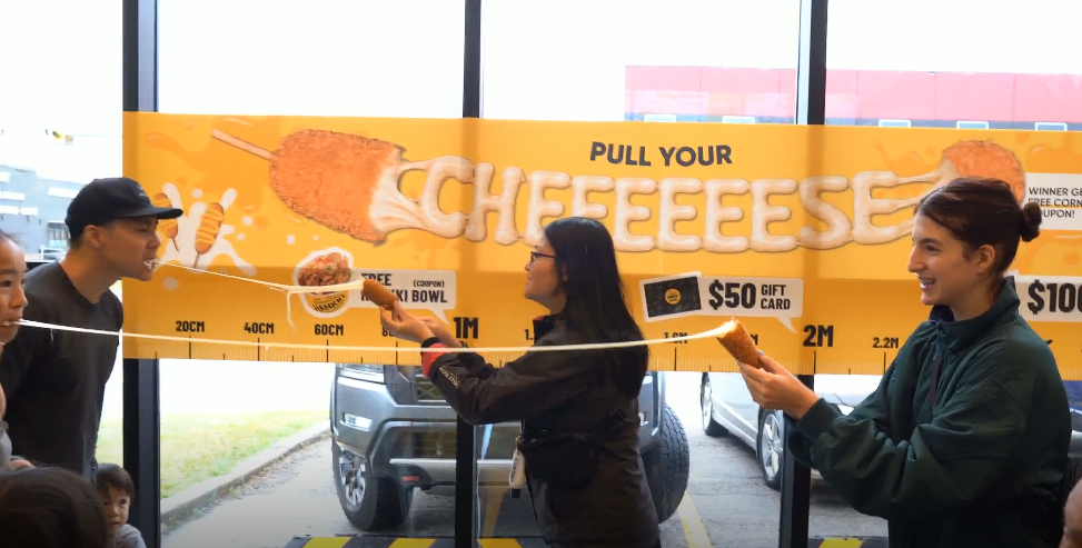 Guests taking part in the Korean corndog Cheese Pull Challenge at HANKKi Highfield