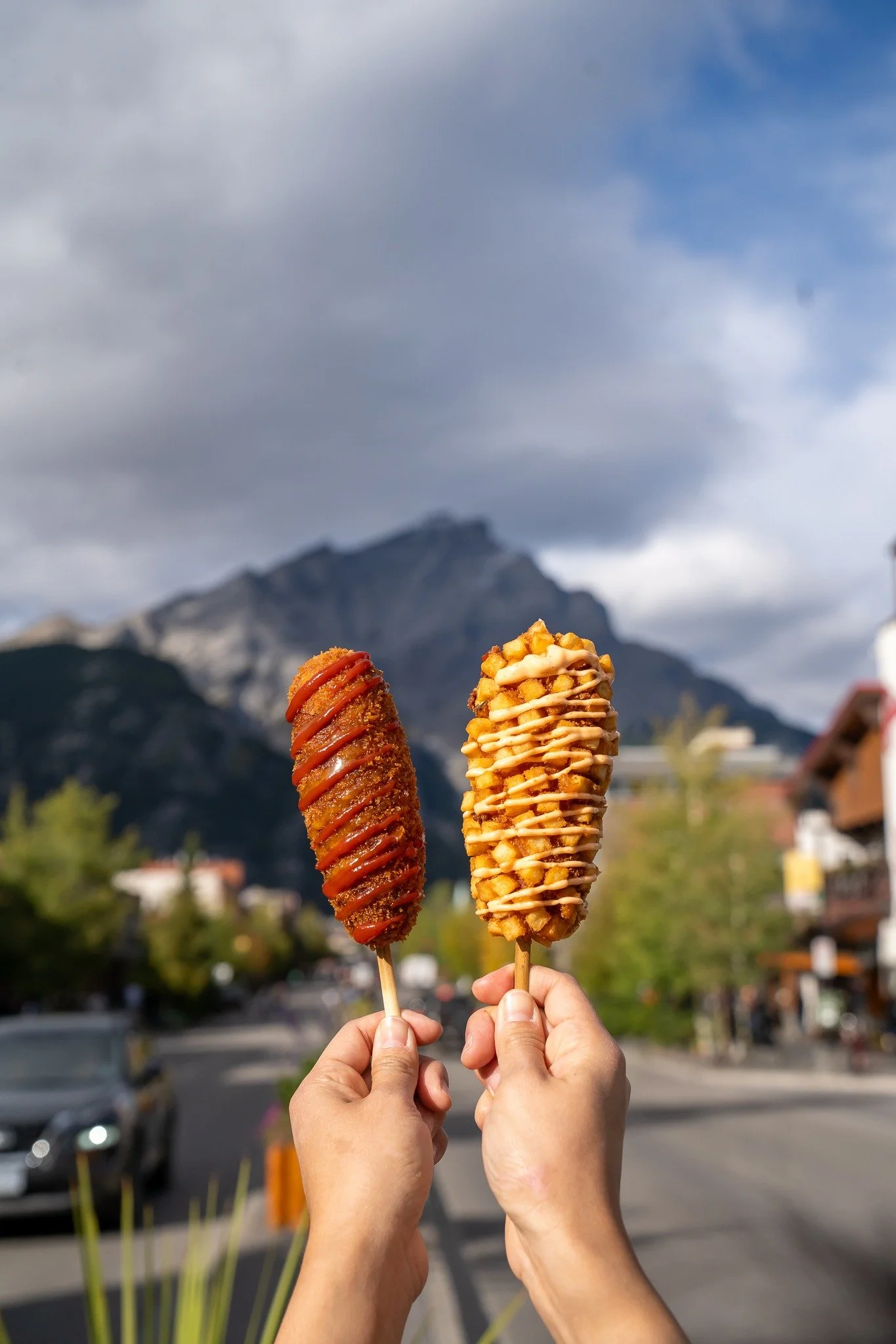 Korean corn dogs from Hankki in Banff Alberta with mountain background
