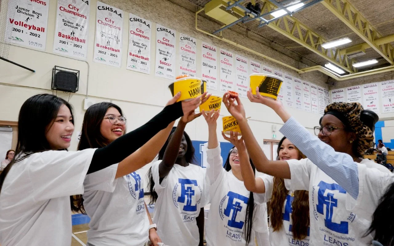 Father Lacombe High School students cheering with HANKKi Bowls during the free HANKKi food truck event