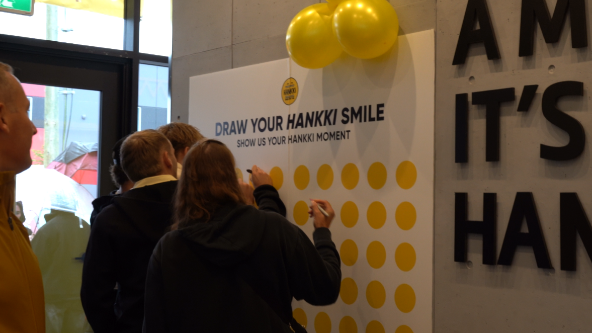 Guests drawing their HANKKi Smile during the Highfield grand opening celebration