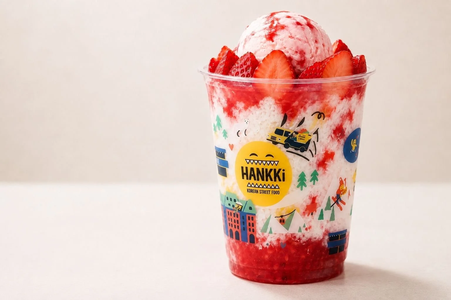 HANKKi Strawberry Bingsu topped with strawberries and strawberry ice cream over fluffy shaved milk ice
