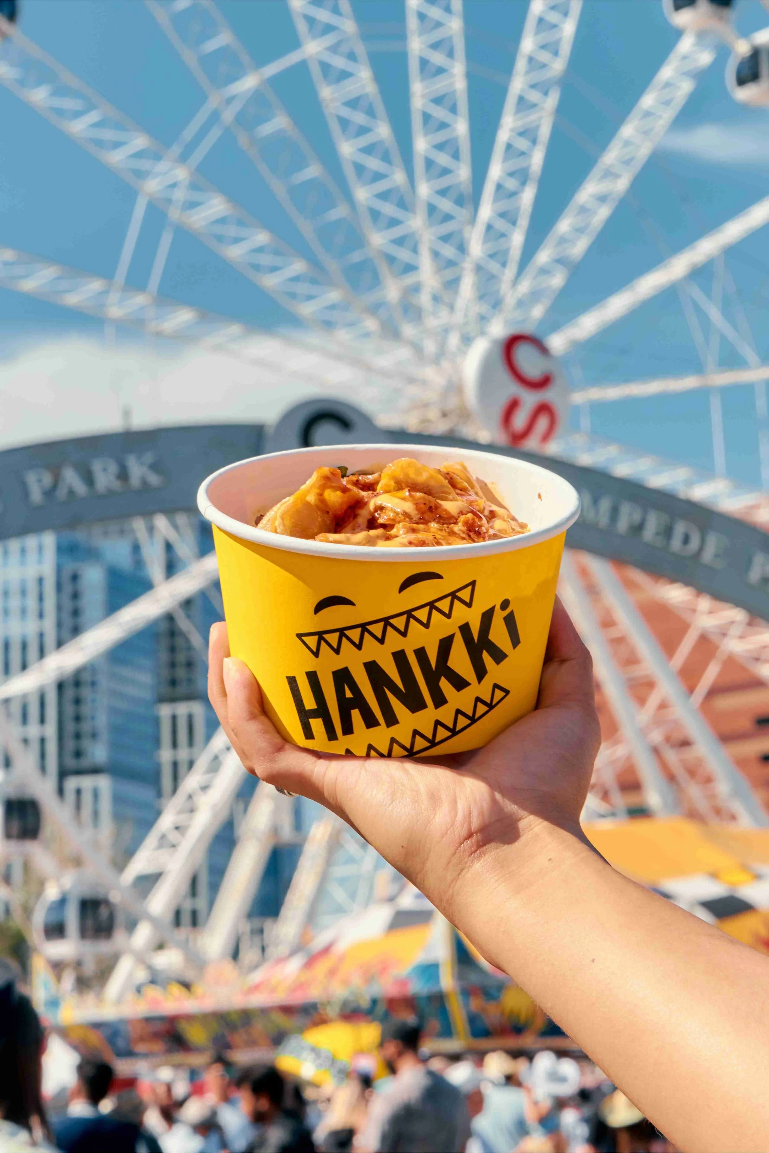 HANKKi Korean street food bowl at Calgary Stampede with rides in the background