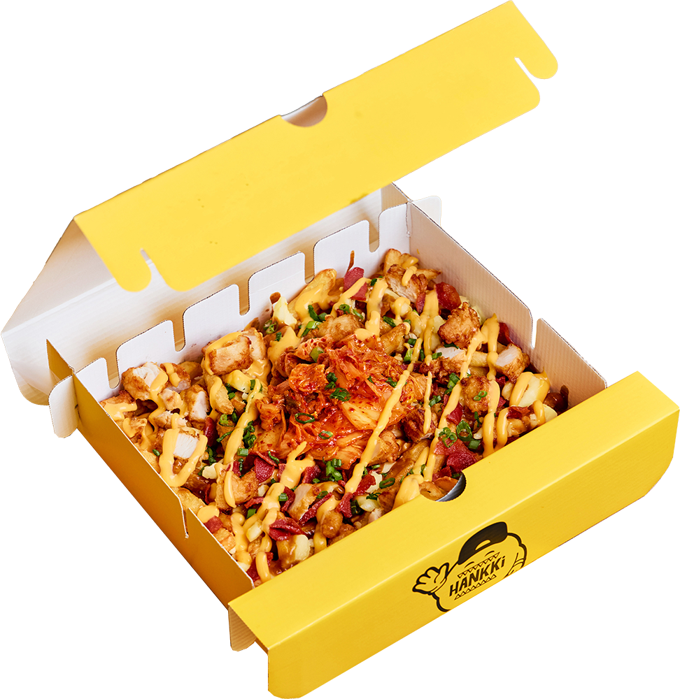 Open pizza box filled with loaded macaroni and cheese topped with kimchi.