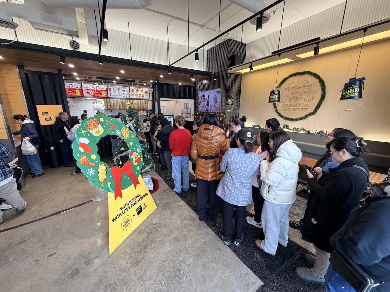 Hankki Charity Day 2025 in-store atmosphere with Giving Back The Love display and customers