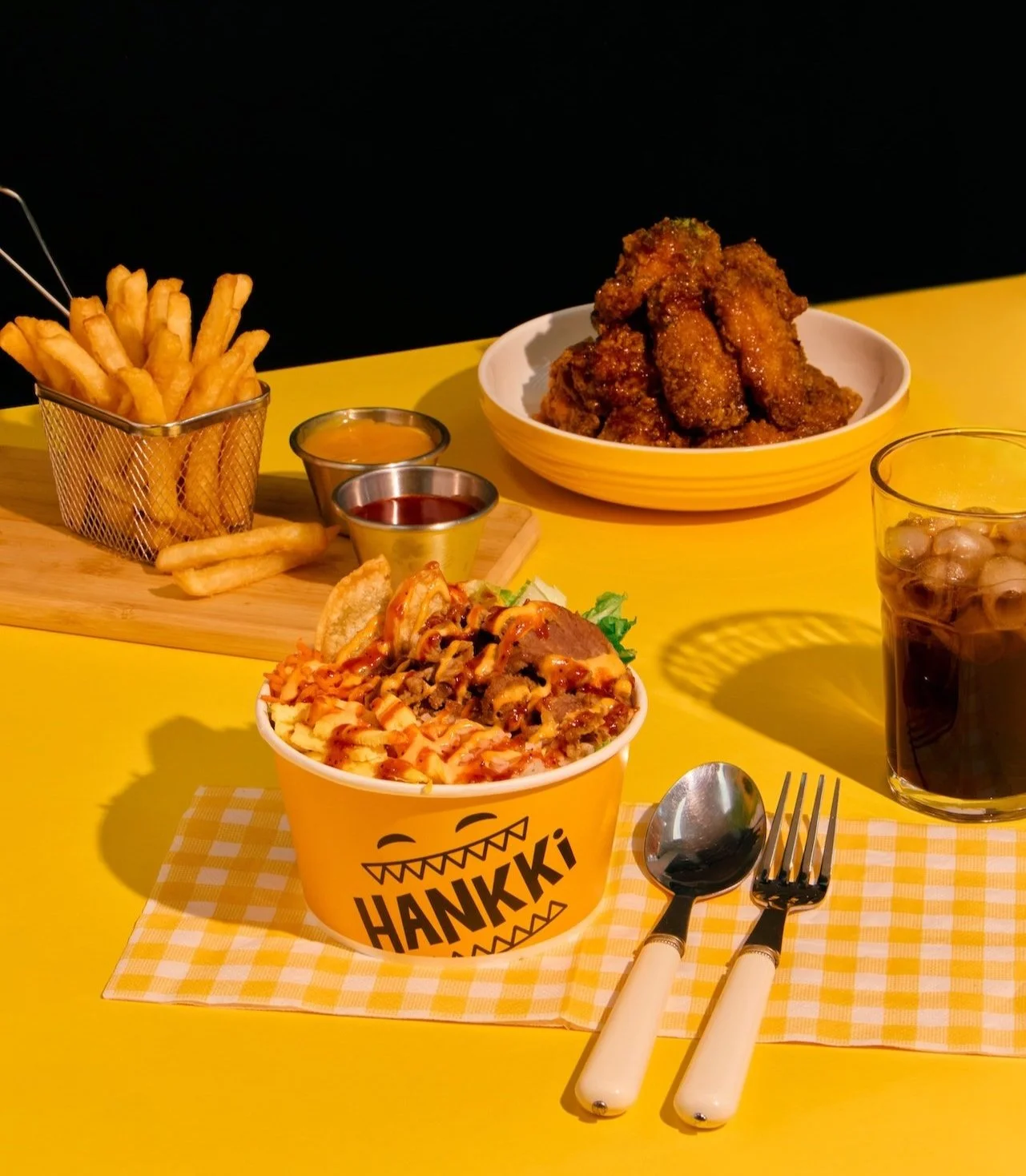 Signature Hankki bowl, honey butter fries, and Korean chicken wings with soda