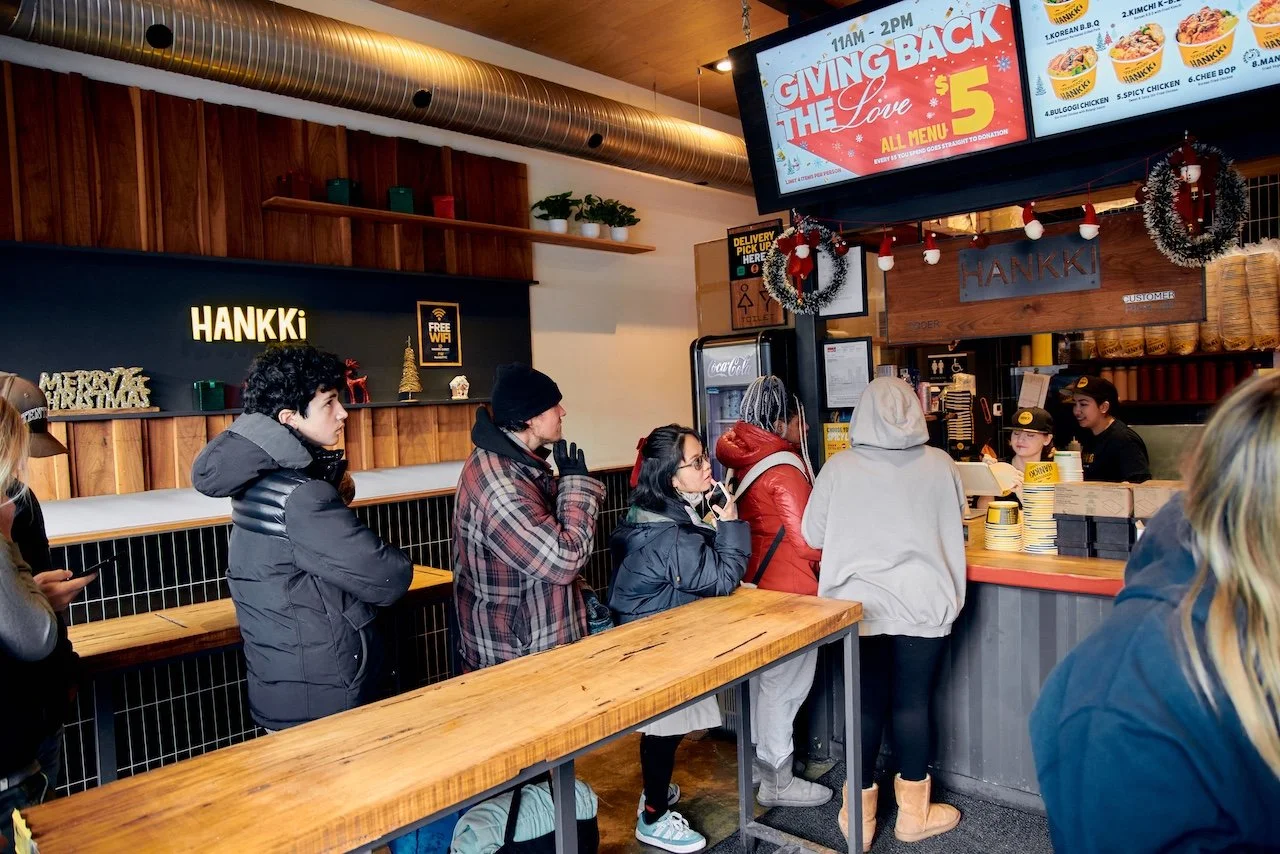 Customers lining up inside Hankki during Charity Day 2025 with Giving Back The Love campaign signage