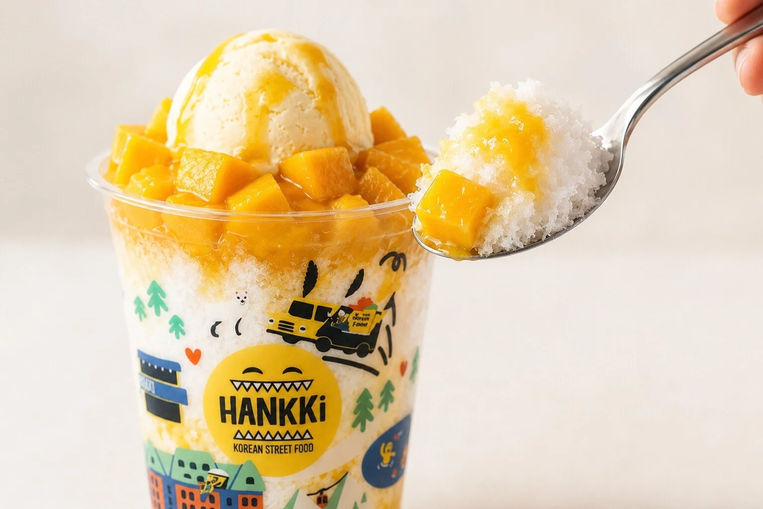 Spoonful of HANKKi Mango Bingsu with fluffy Korean shaved milk ice, mango and ice cream