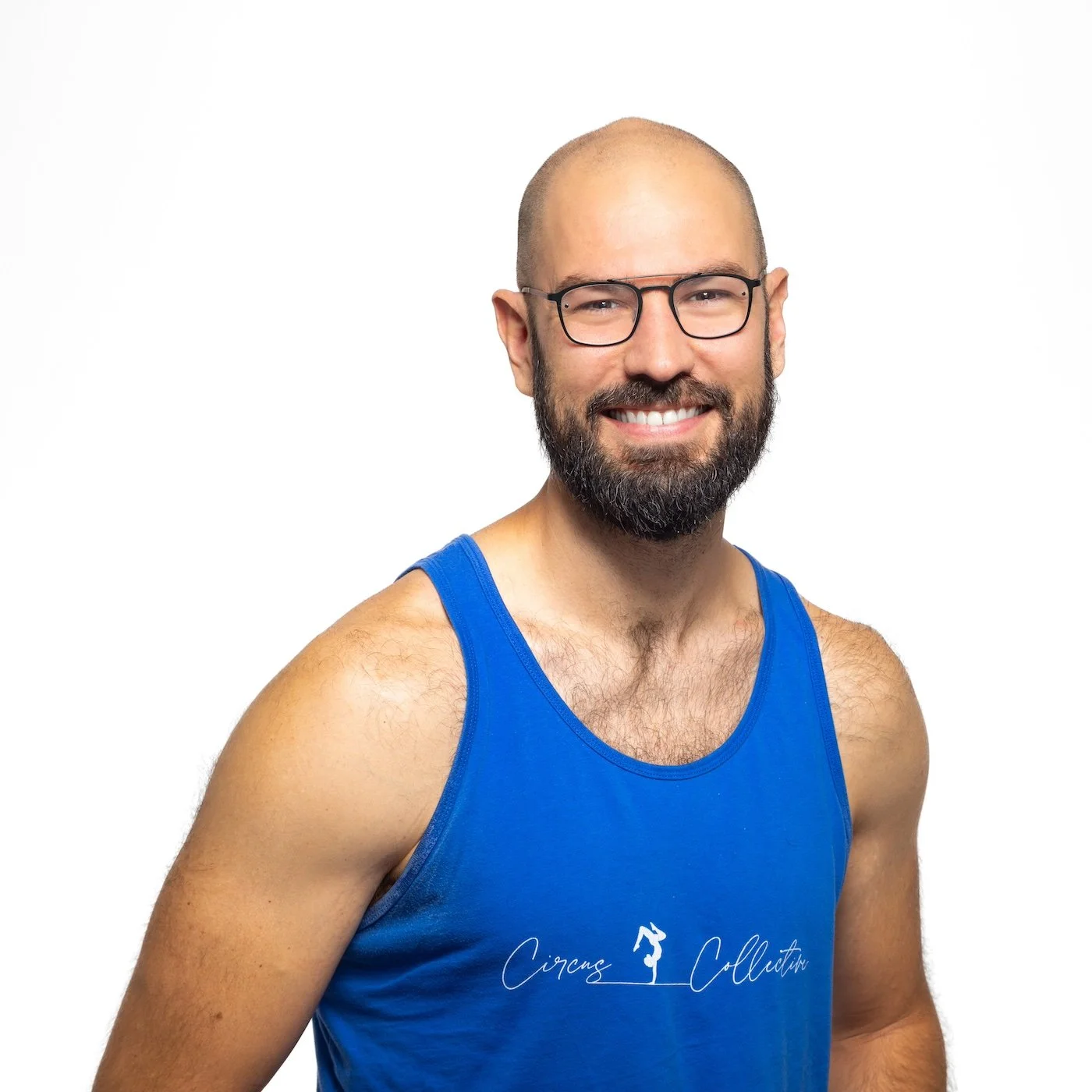 A headshot of Dr. Robert Adams - a smiling man with glasses and a beard wearing a blue tank top with 'Circus Collective' logo, standing against a white background.