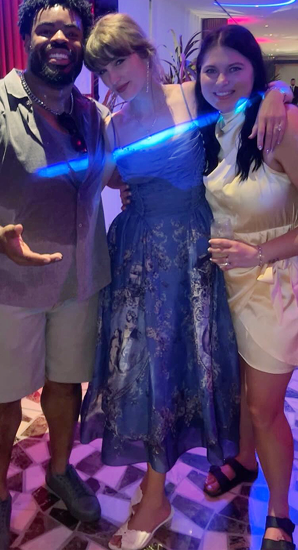 Taylor Swift attends the wedding of Kansas City Chiefs player George Karlaftis with Travis Kelce wearing a blue Zimmermann mermaid dress.