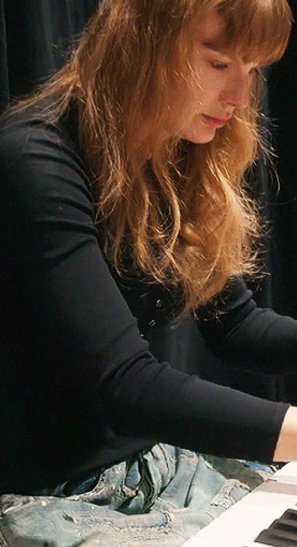 Taylor Swift during acoustic rehearsal at the Eras Tour in her Disney+ docuseries The End of an Era wearing Magnolia Pearl distressed denim.