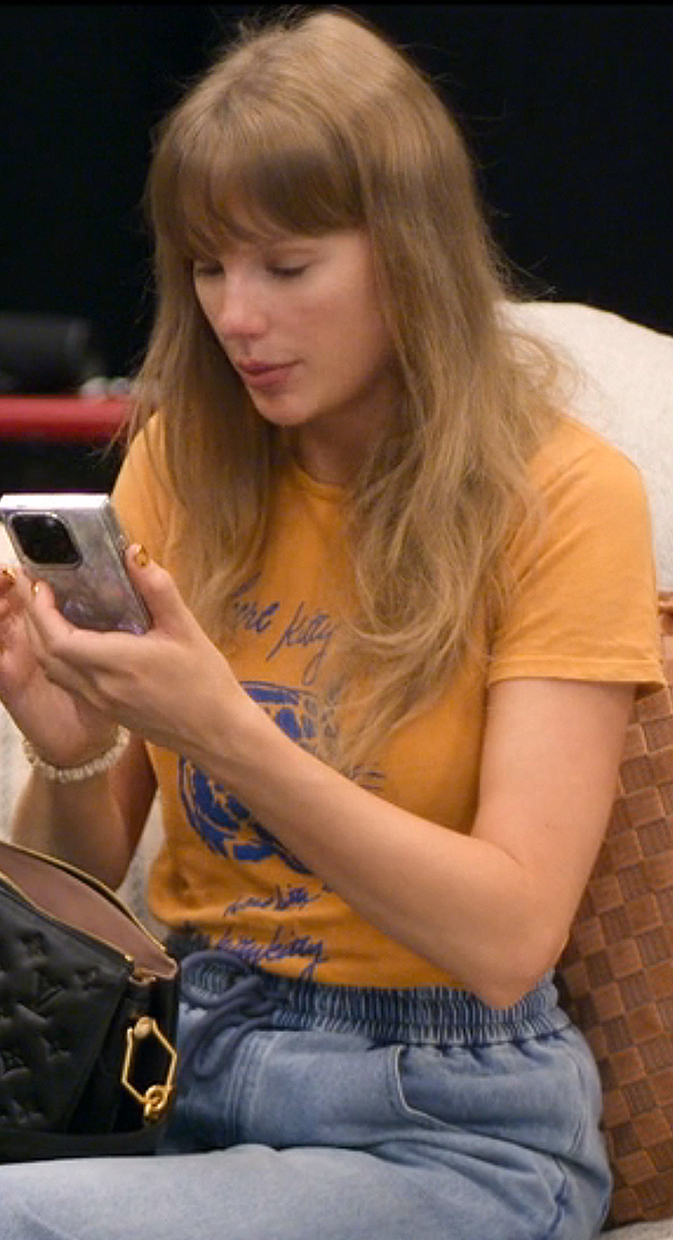 Taylor Swift backstage at the Eras Tour in her Disney+ docuseries The End of an Era wearing a Mother kitty t-shirt.