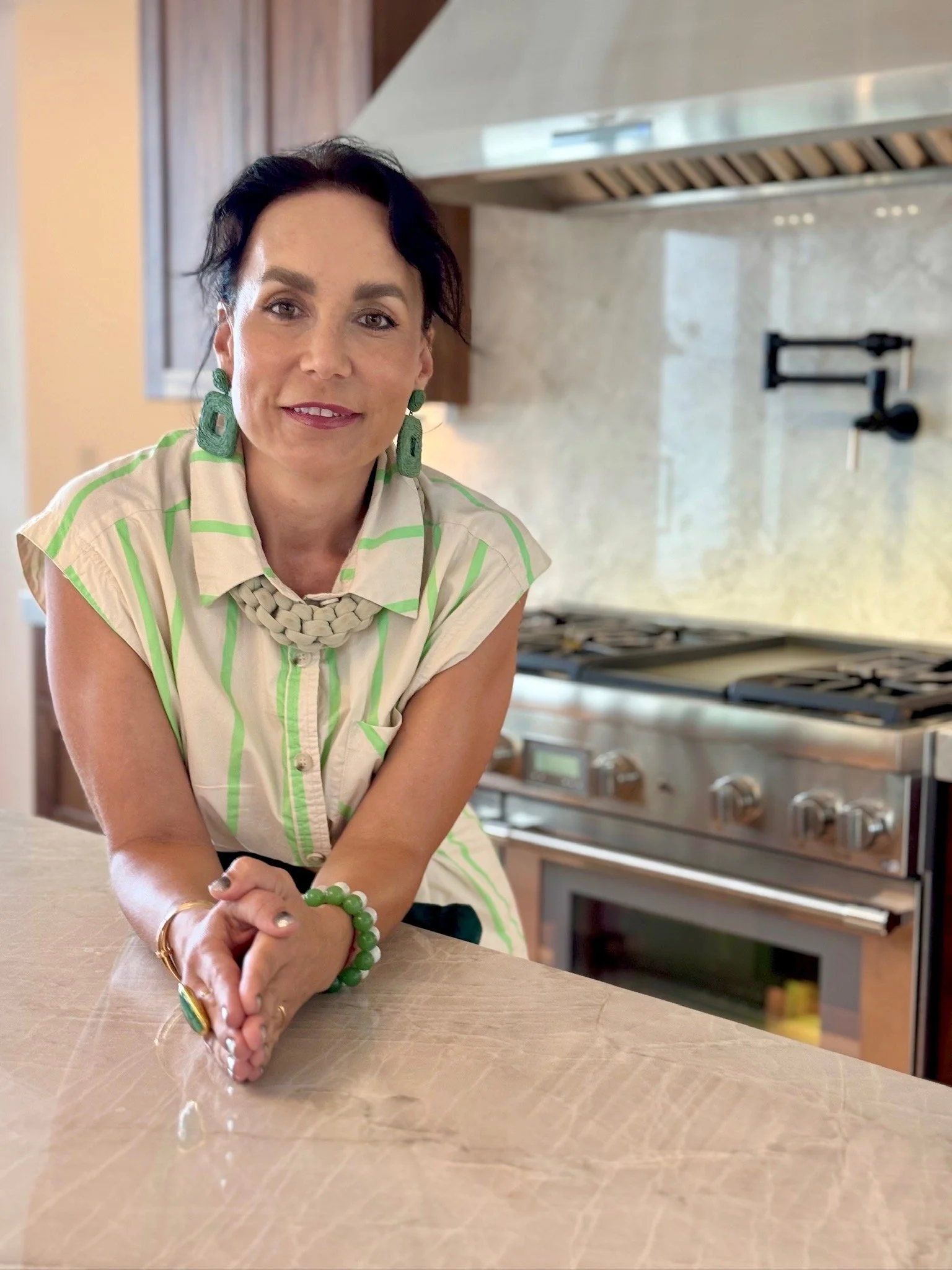 Diana Roberts in a kitchen, leaning on the counter