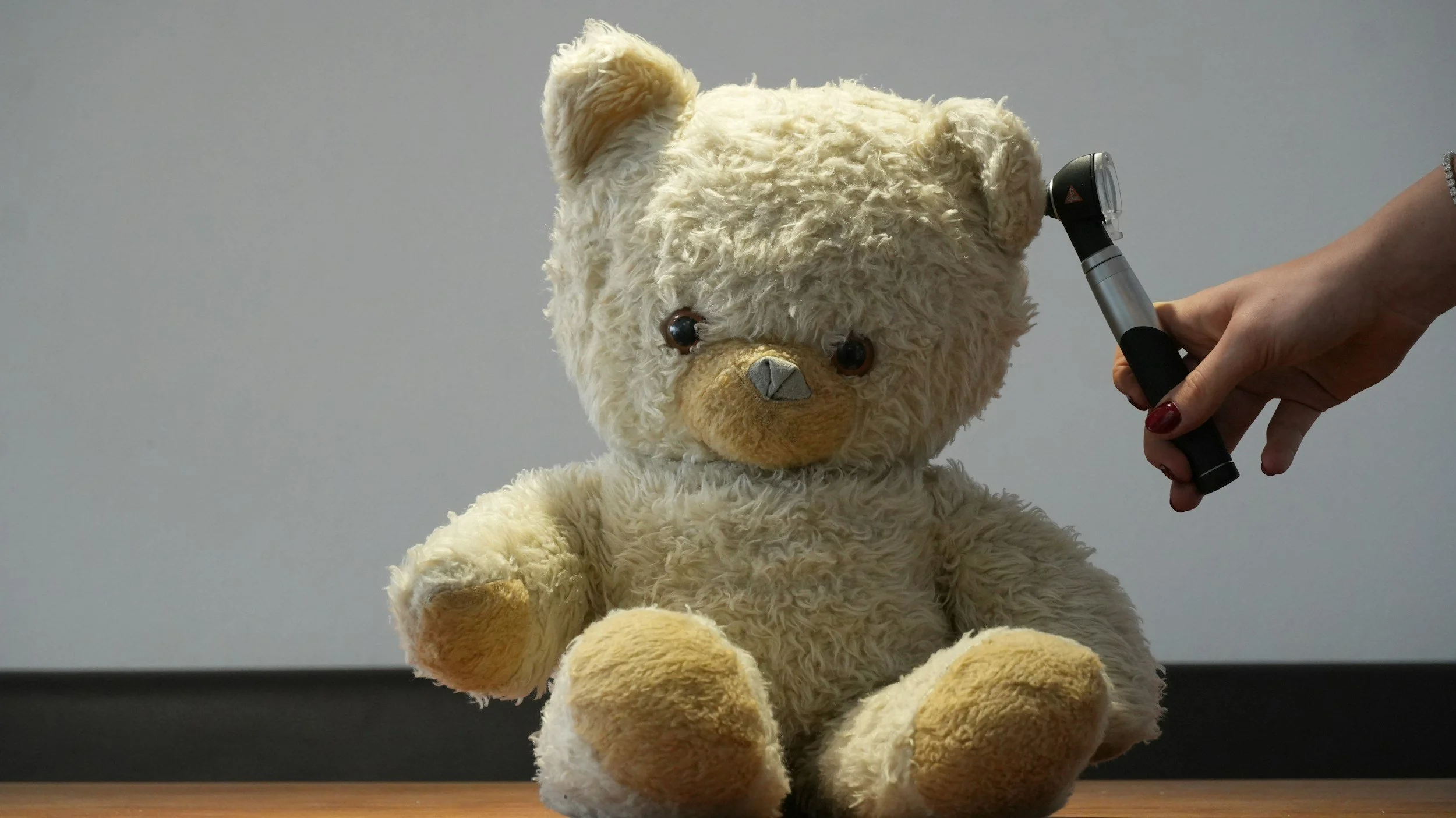 Teddy bear otoscopic exam to help kids understand ear exams aren't scary