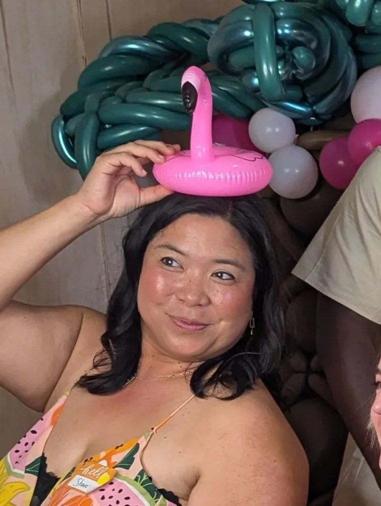 Mom smiling with flamingo on head