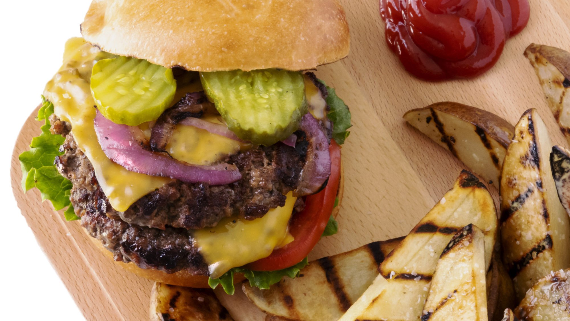 Food photo of a juicy cheeseburger and grilled french fries made for product POP. Photography and Food Styling by Chris Wulff