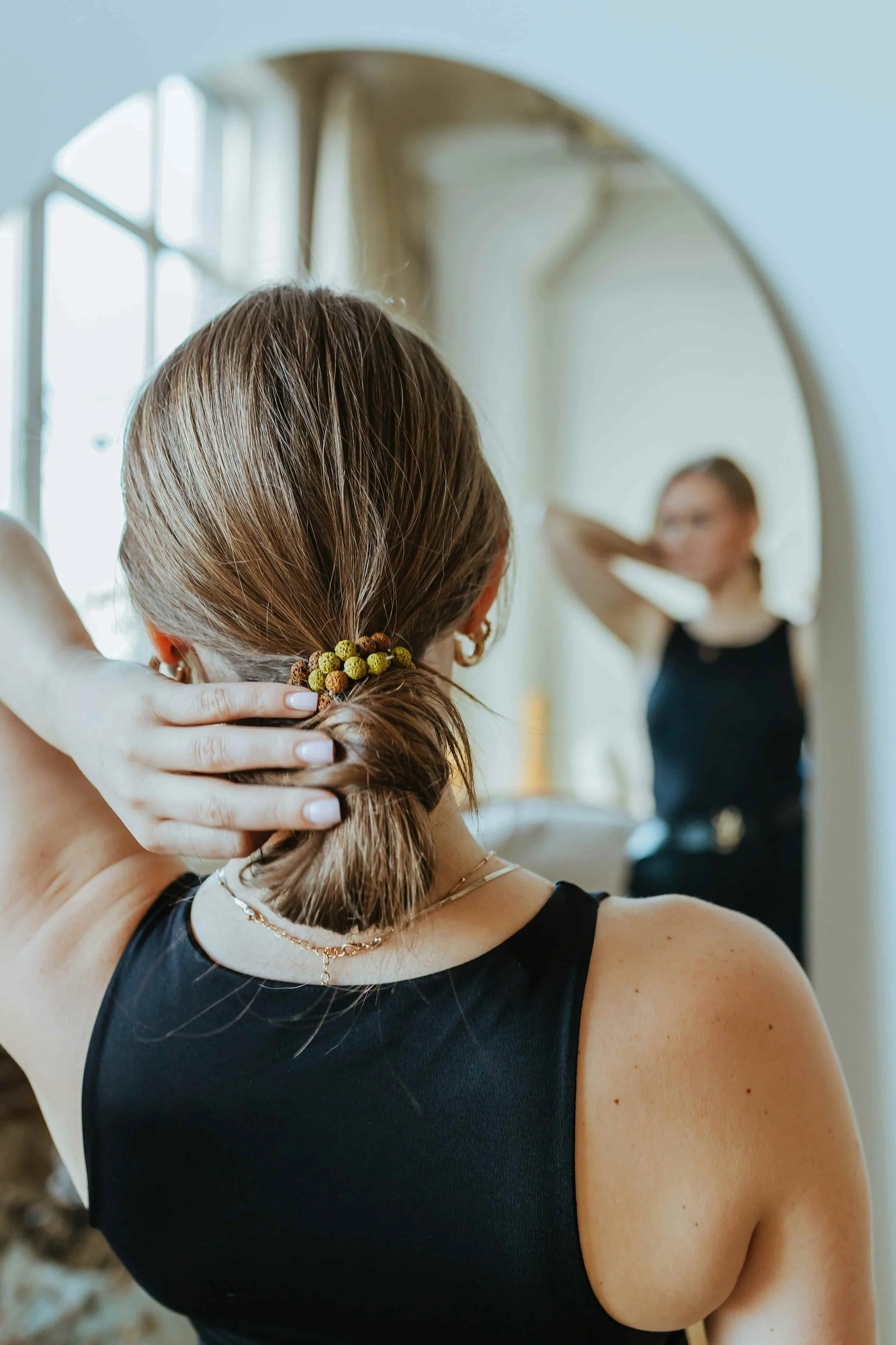A woman examining herself in the mirror, struggling with distorted eating and body image concerns.