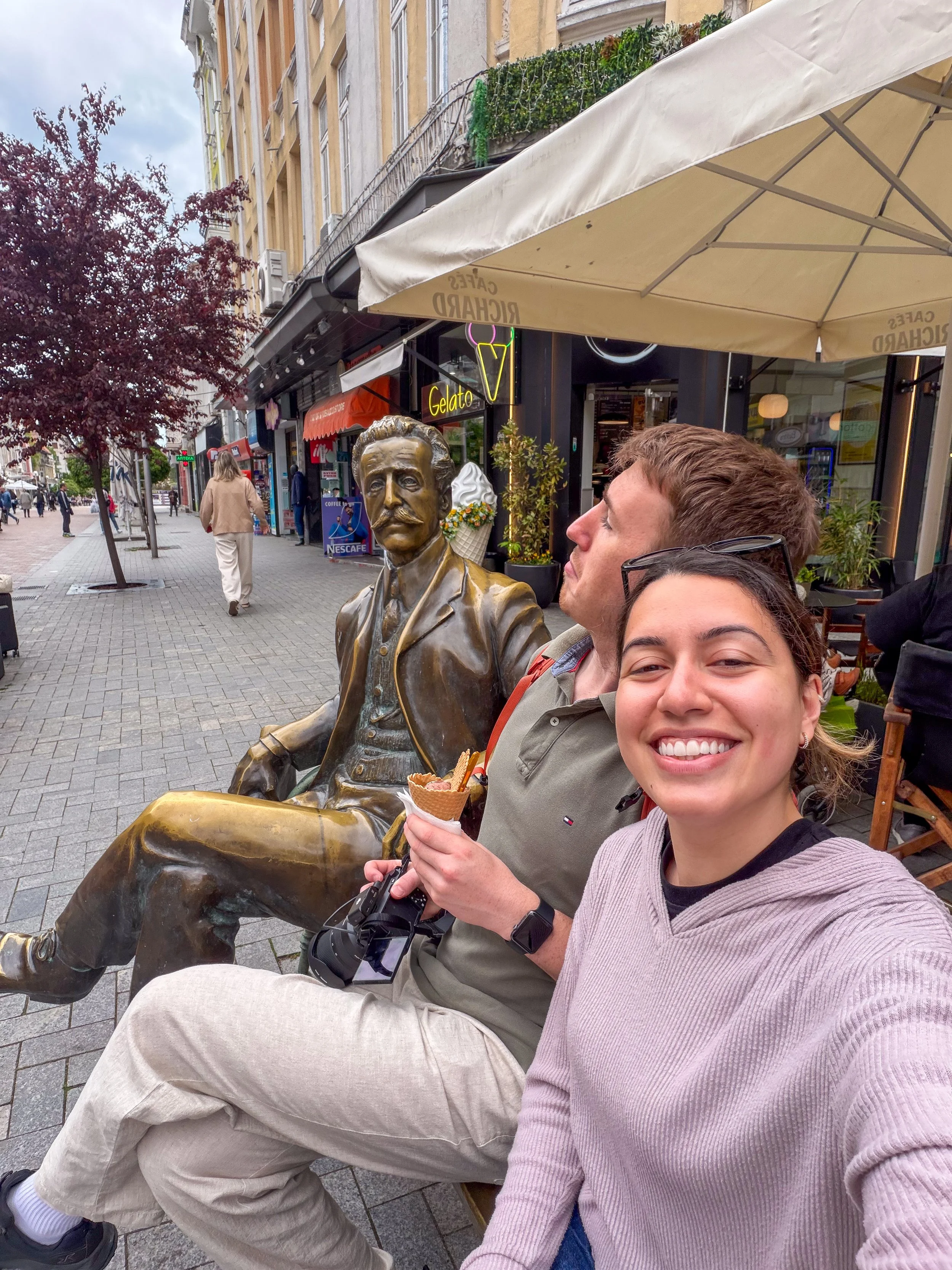 Carol and Max selfie at Varna city centre with statue of architect Dabko Dabkov