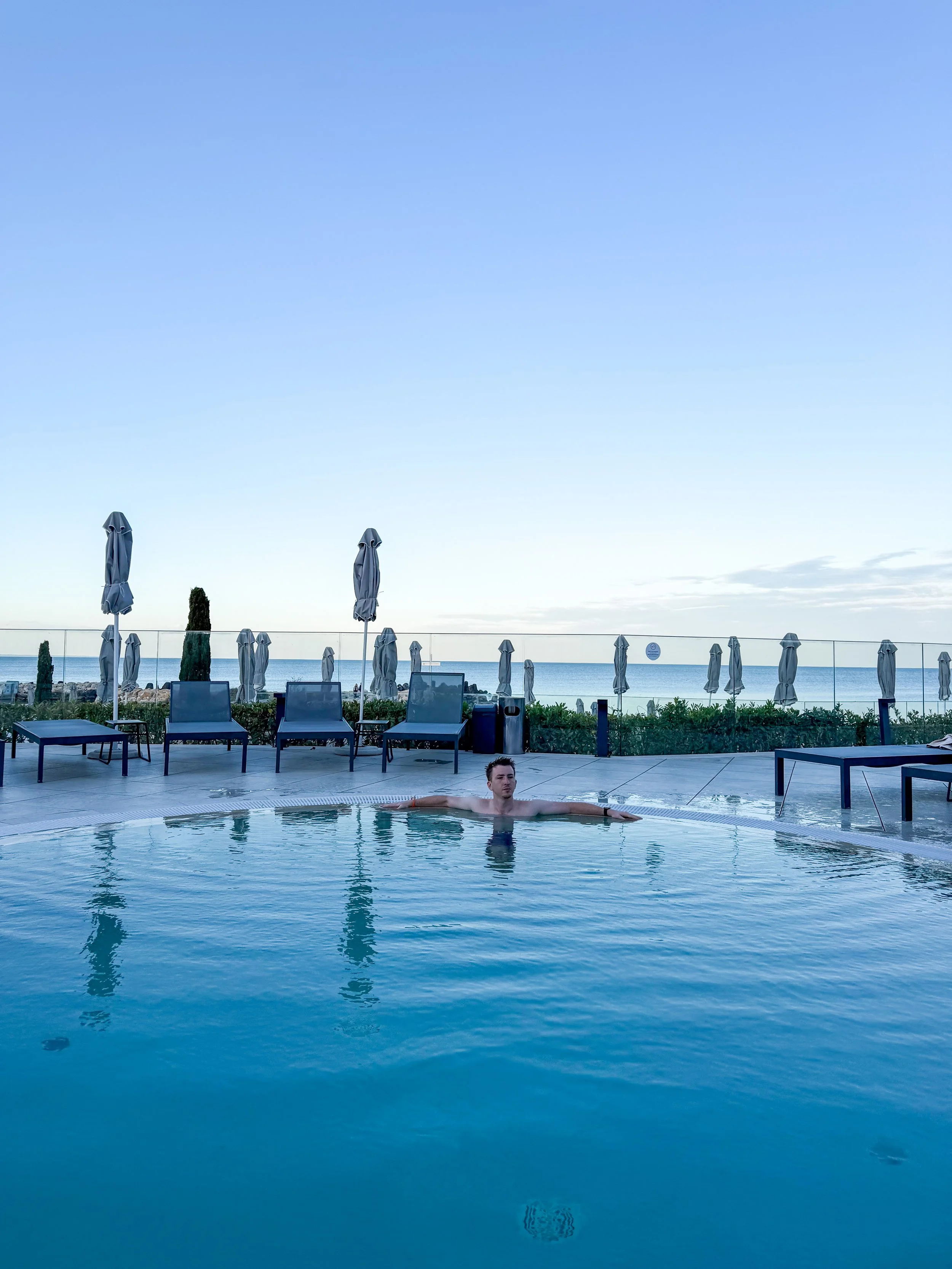 Max enjoying the heated pool at Aquahouse Varna sunset