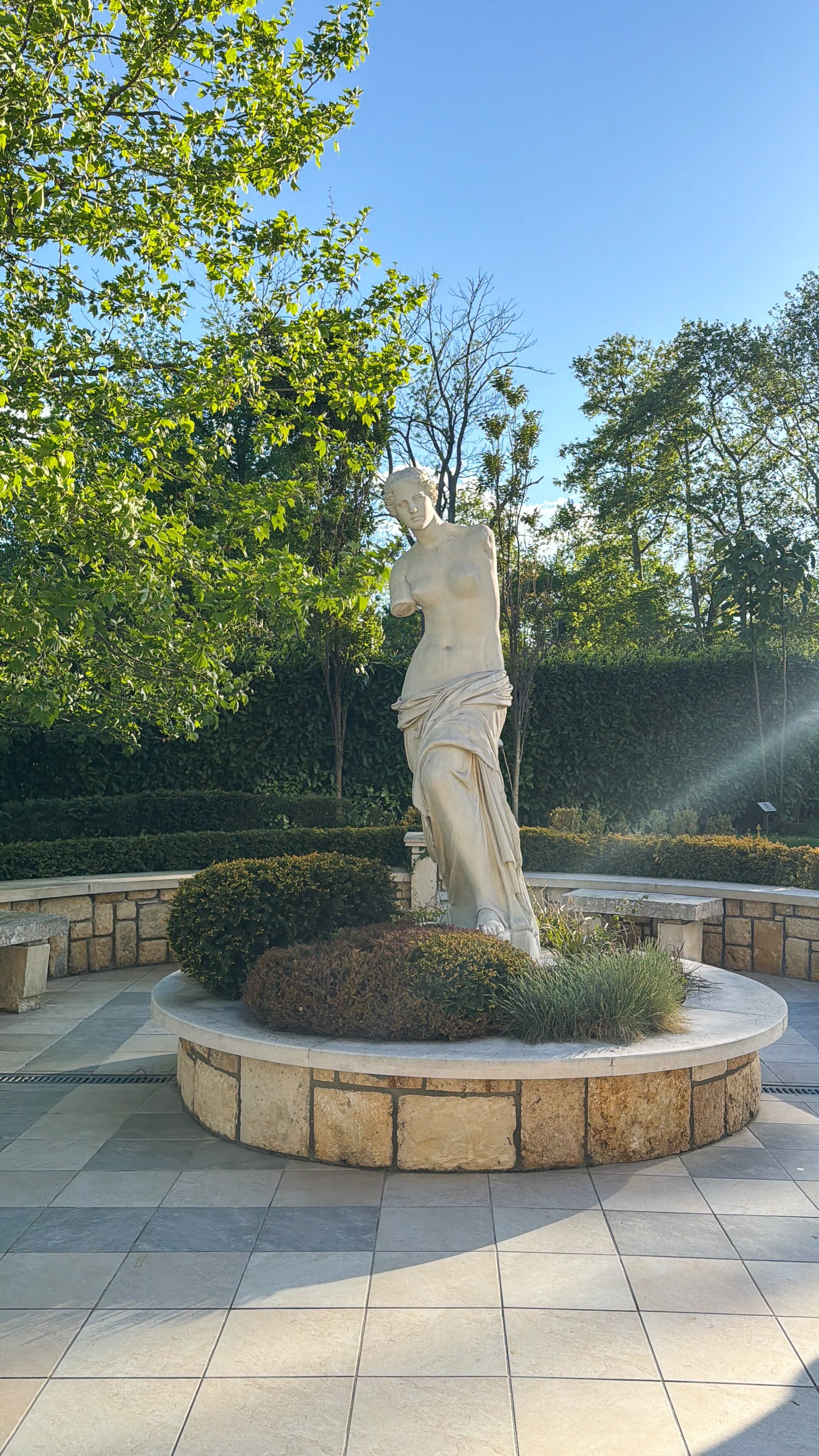 Roma-style statue at Astor Garden Hotel gardens.jpg
