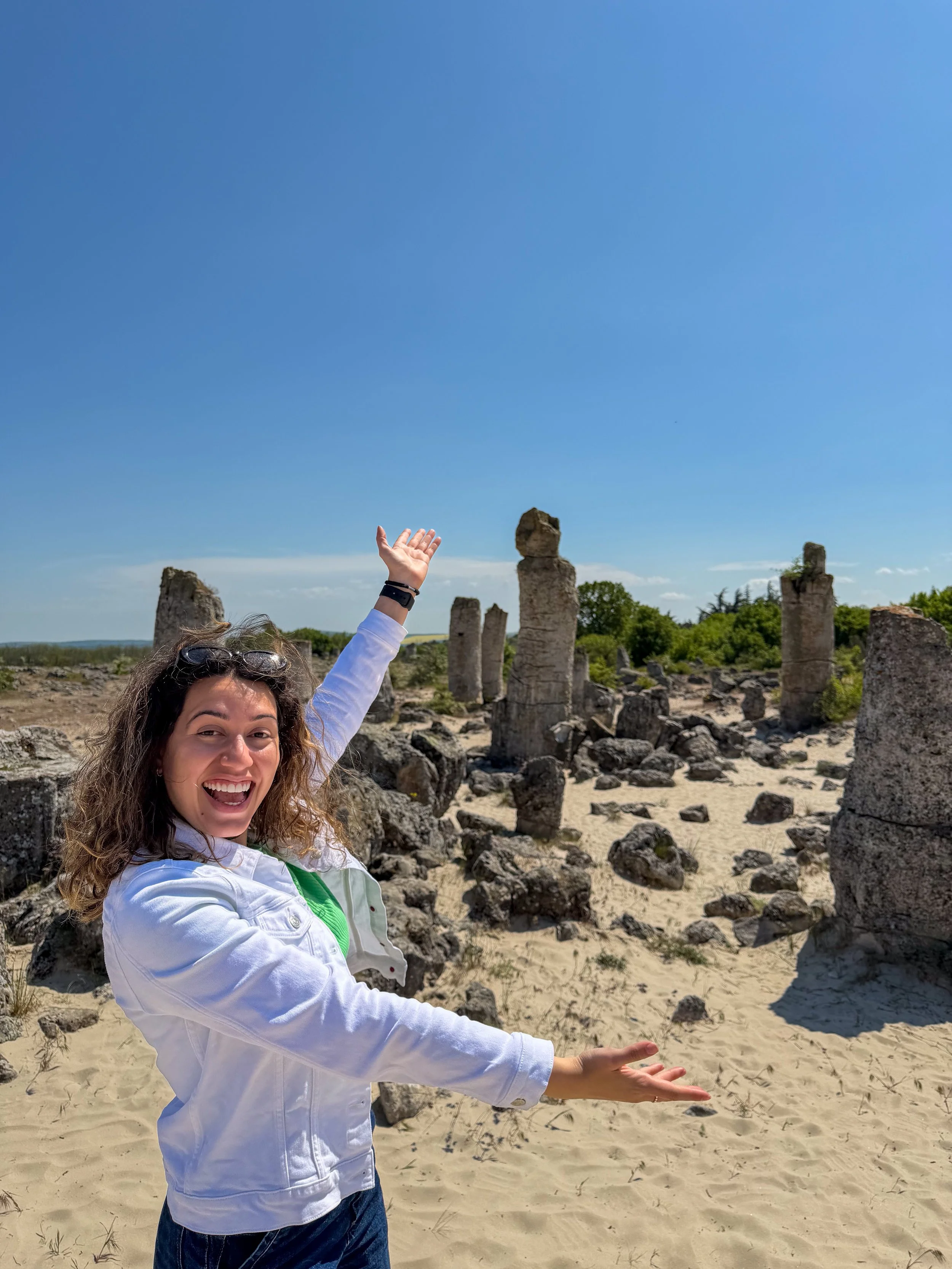 Carol posing in front of stone pillars at the Stone Forest, Varna, Bulgaria