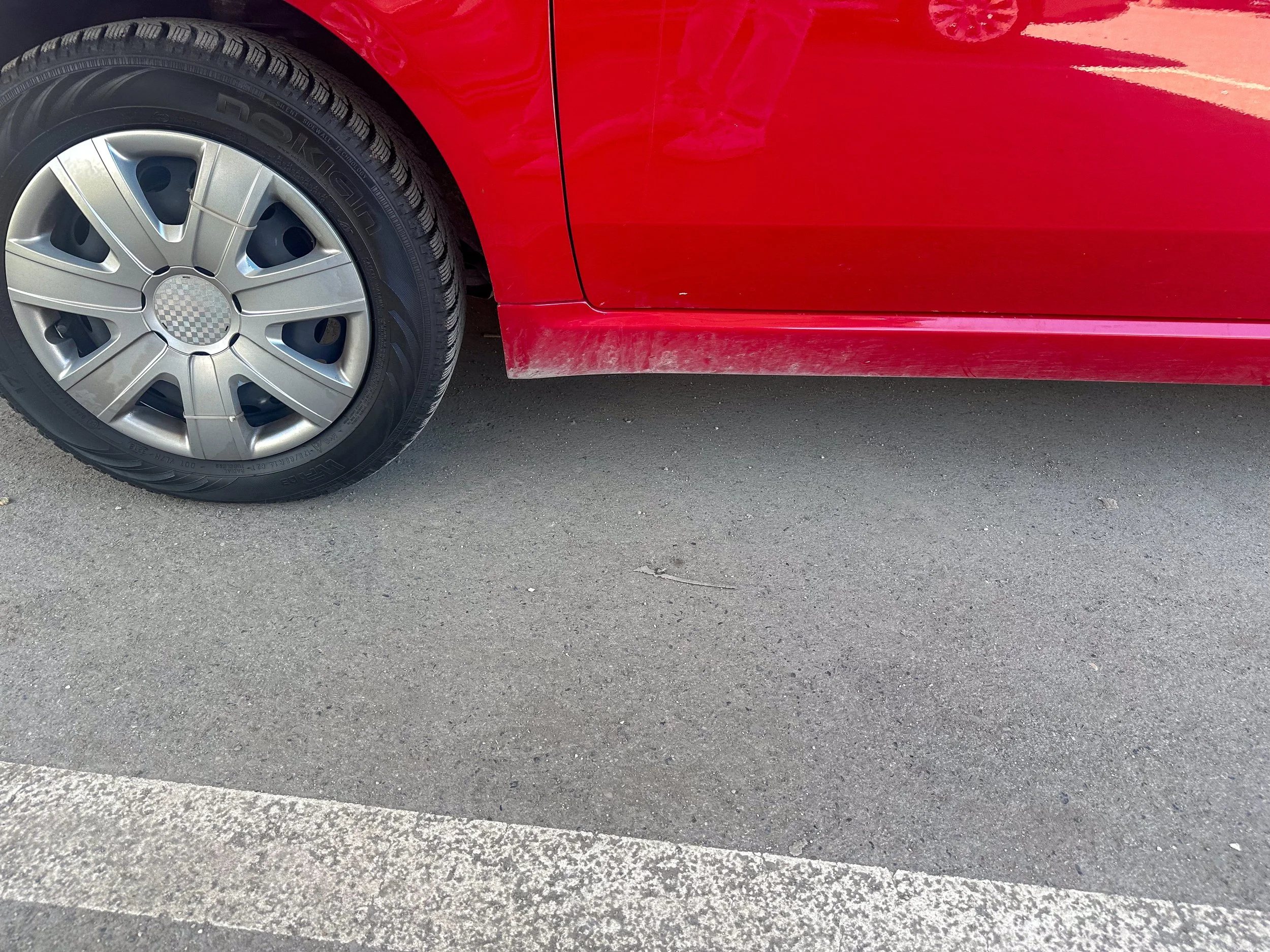 Dirty mud-guard on car rental at Tirana Airport.jpg