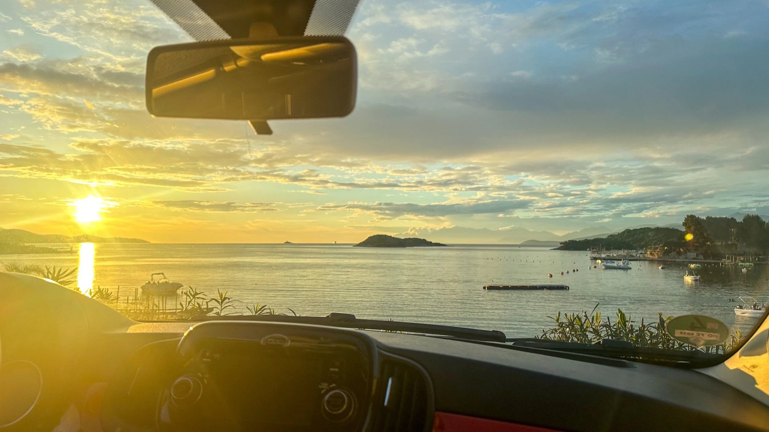 Watching the sunset in a car in Ksamil by the beach
