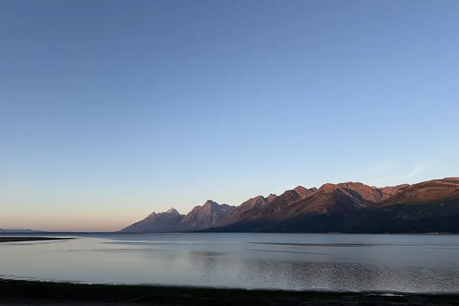 Mountains over water at sunrise