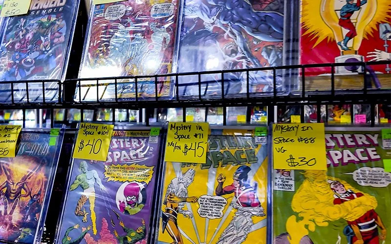 Shelves of various comic books with price tags