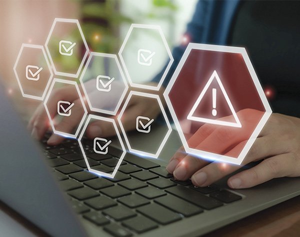 Graphic depicting cyber security and alert on laptop