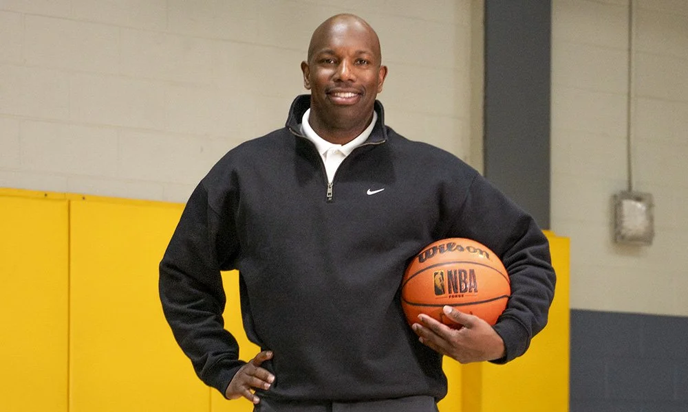 Marcus Mason, founder of Nothing But Net Coaching posing for a portrait holding a basketball