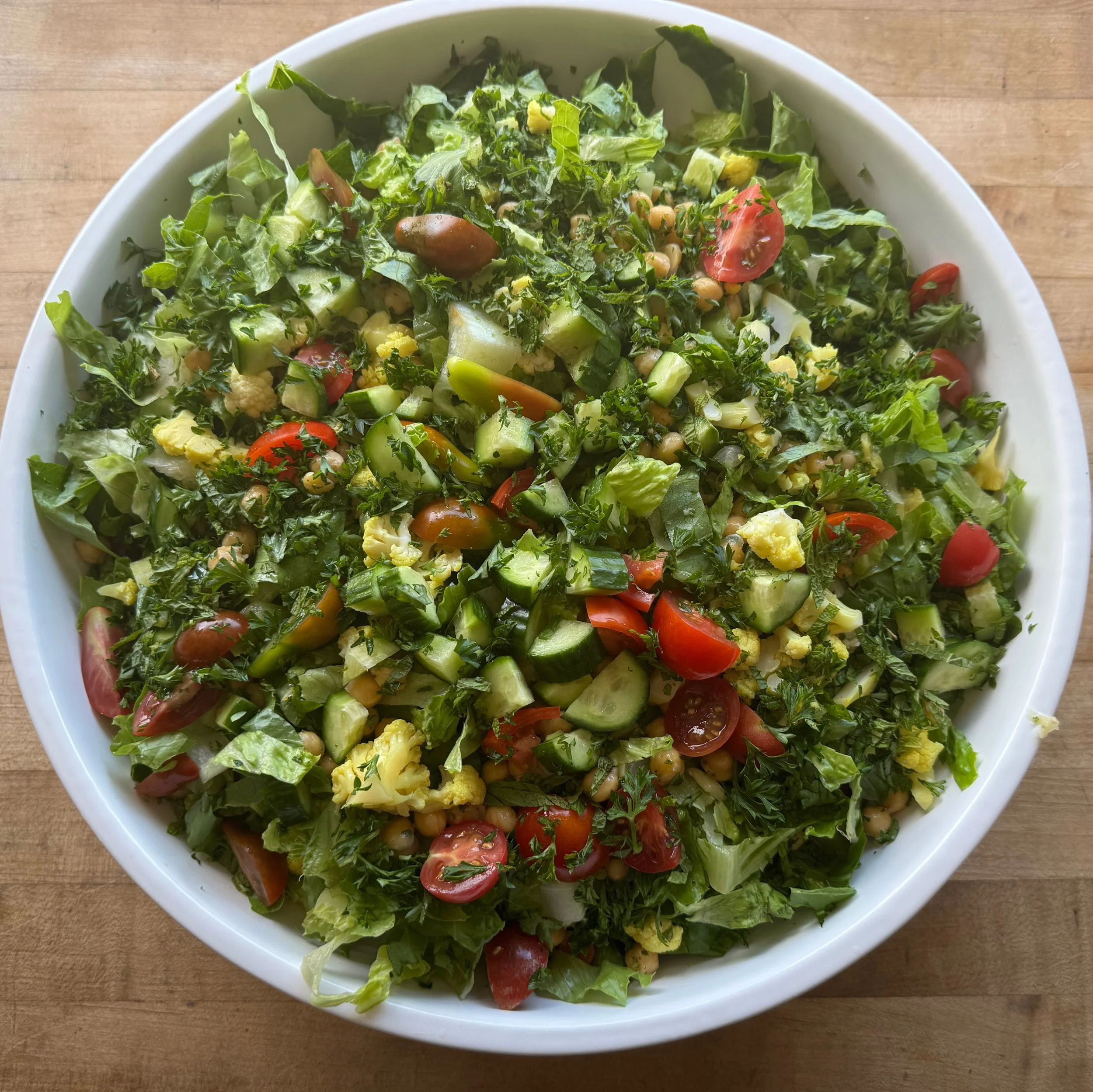 green salad in a bowl. shirazi salad, tomato cucumber, lettuce and parsley
