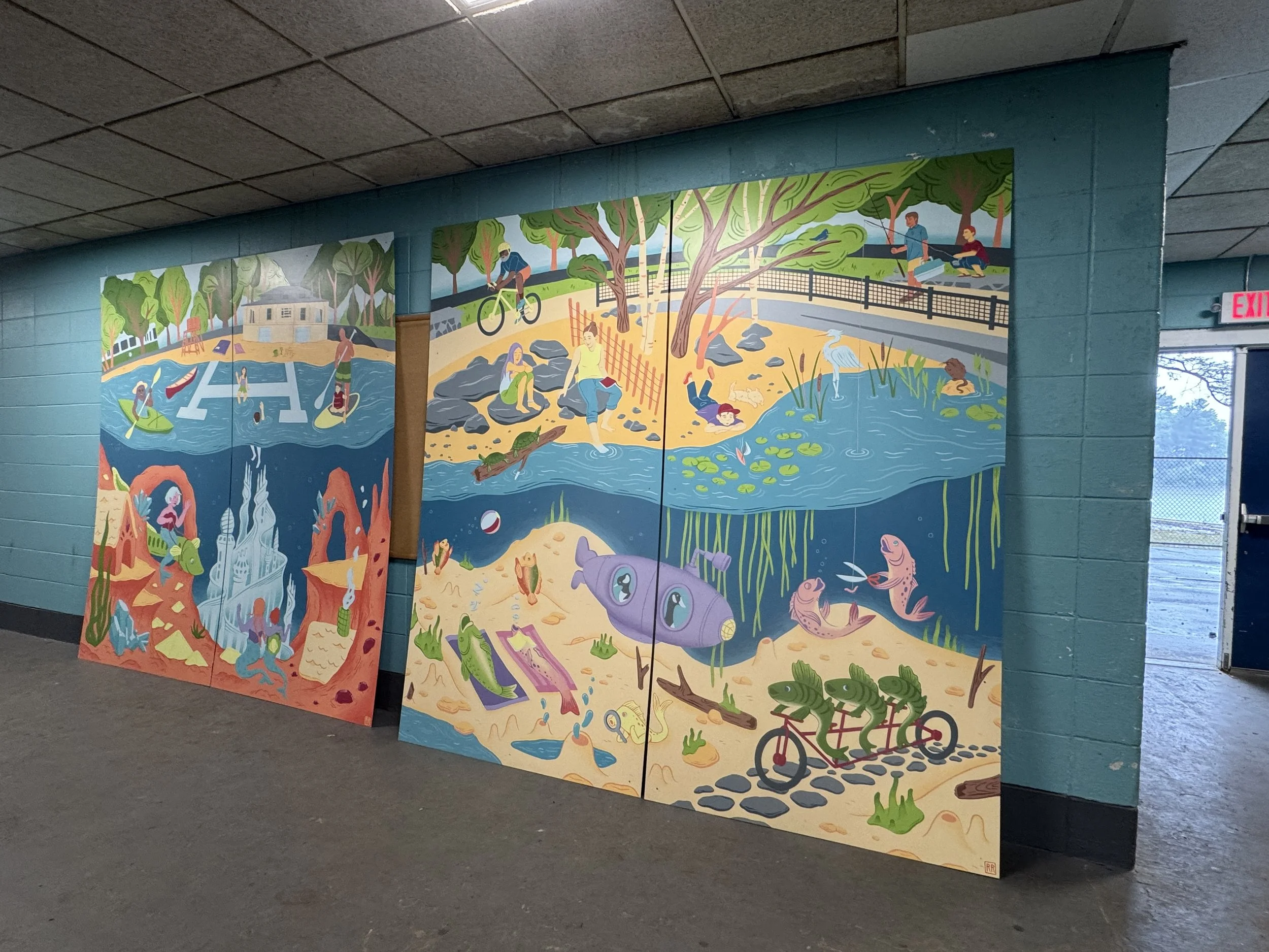 Image of two large colorful panel murals of underwater scenes at a lake leaning against building wall