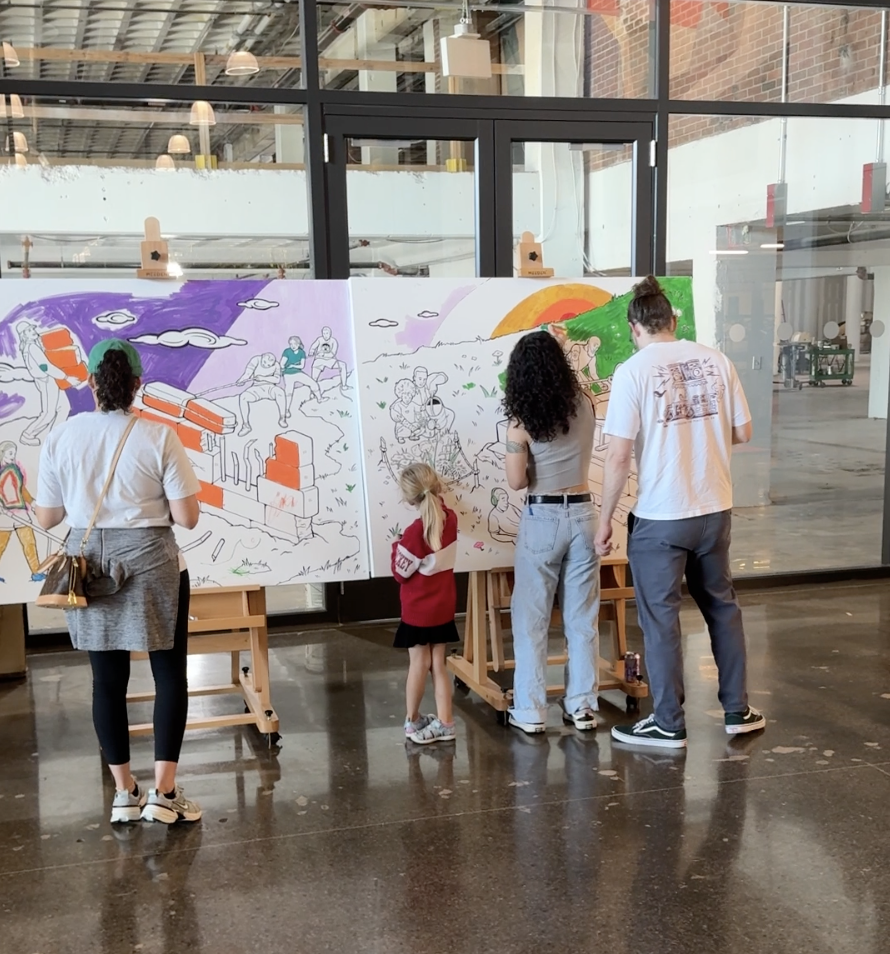 Photo of happy participants, both youth and adults, using paint markers to create a color-by-numbers canvas mural together at a nonprofit event