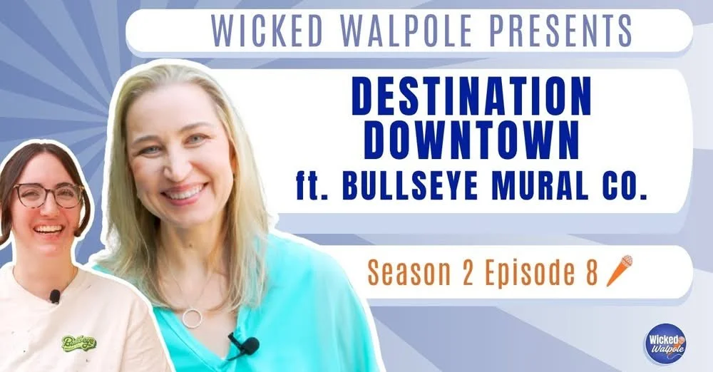 Video cover art for 'Wicked Walpole' episode featuring two smiling women, one with glasses and the other with blond hair, promoting 'Destination Downtown' at the BULLSEYE MURAL CO., season 2, episode 8.