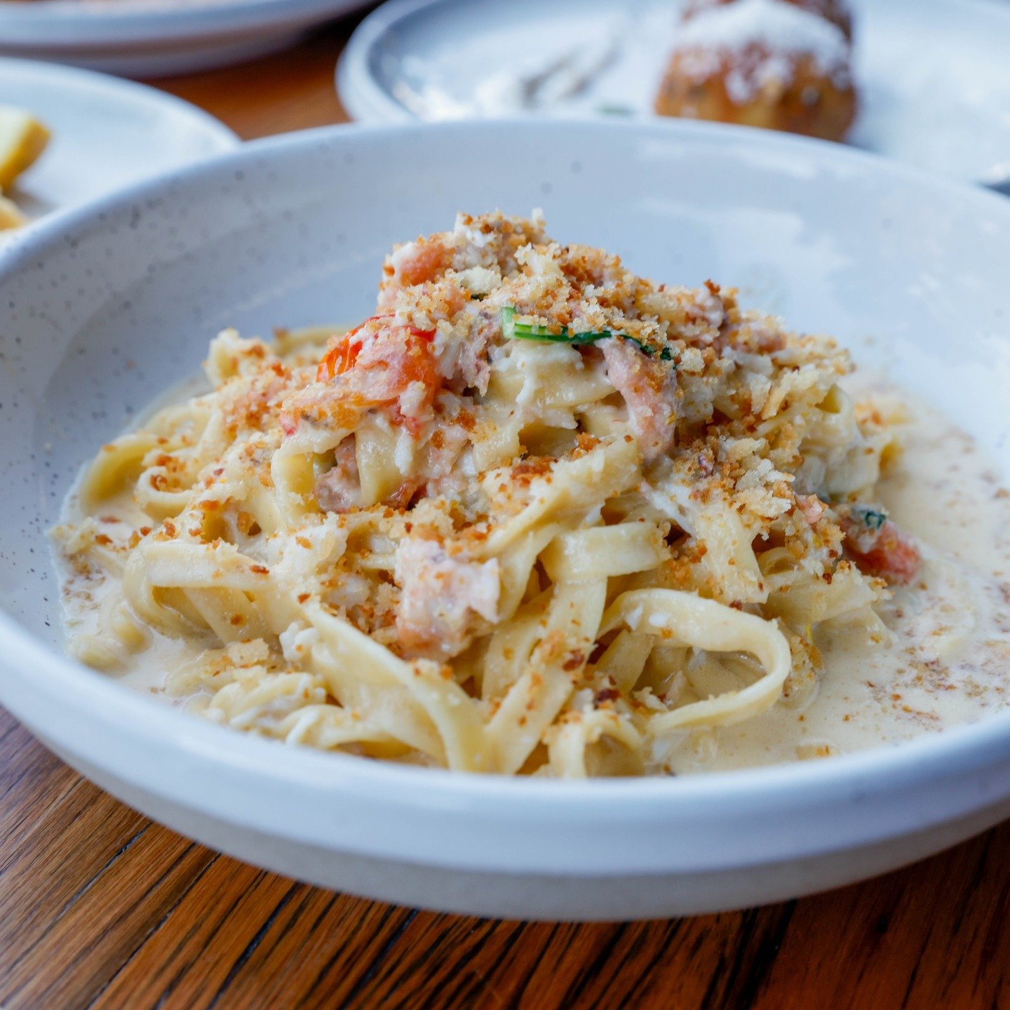 Silky ribbons of fettuccine tossed in a rich, creamy sauce with sweet red &amp; yellow cherry tomatoes, delicate crab meat, fresh basil, and finished with a sprinkle of aromatic toasted breadcrumbs.

It&rsquo;s coastal Italy on a plate at La Piazzett