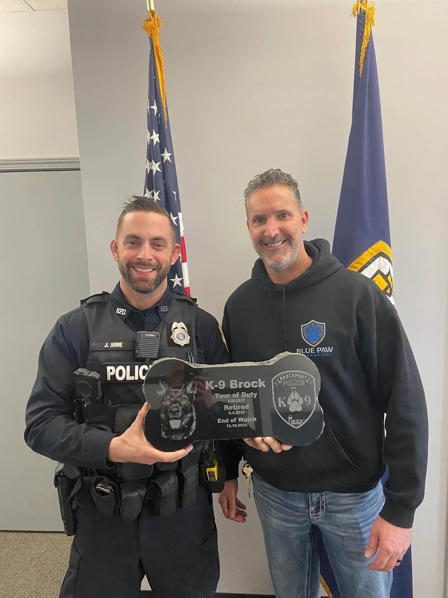 Granite grave marker engraved with dog picture and dates of service for a deceased K9 officer.