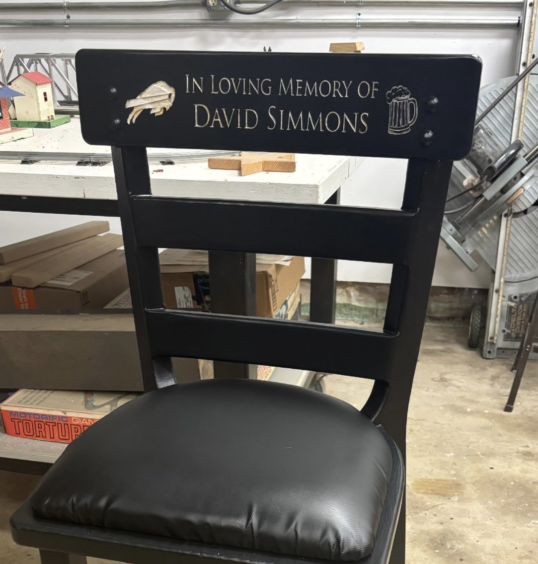 Counter height stool engraved with "in loving memory of David Simmons.