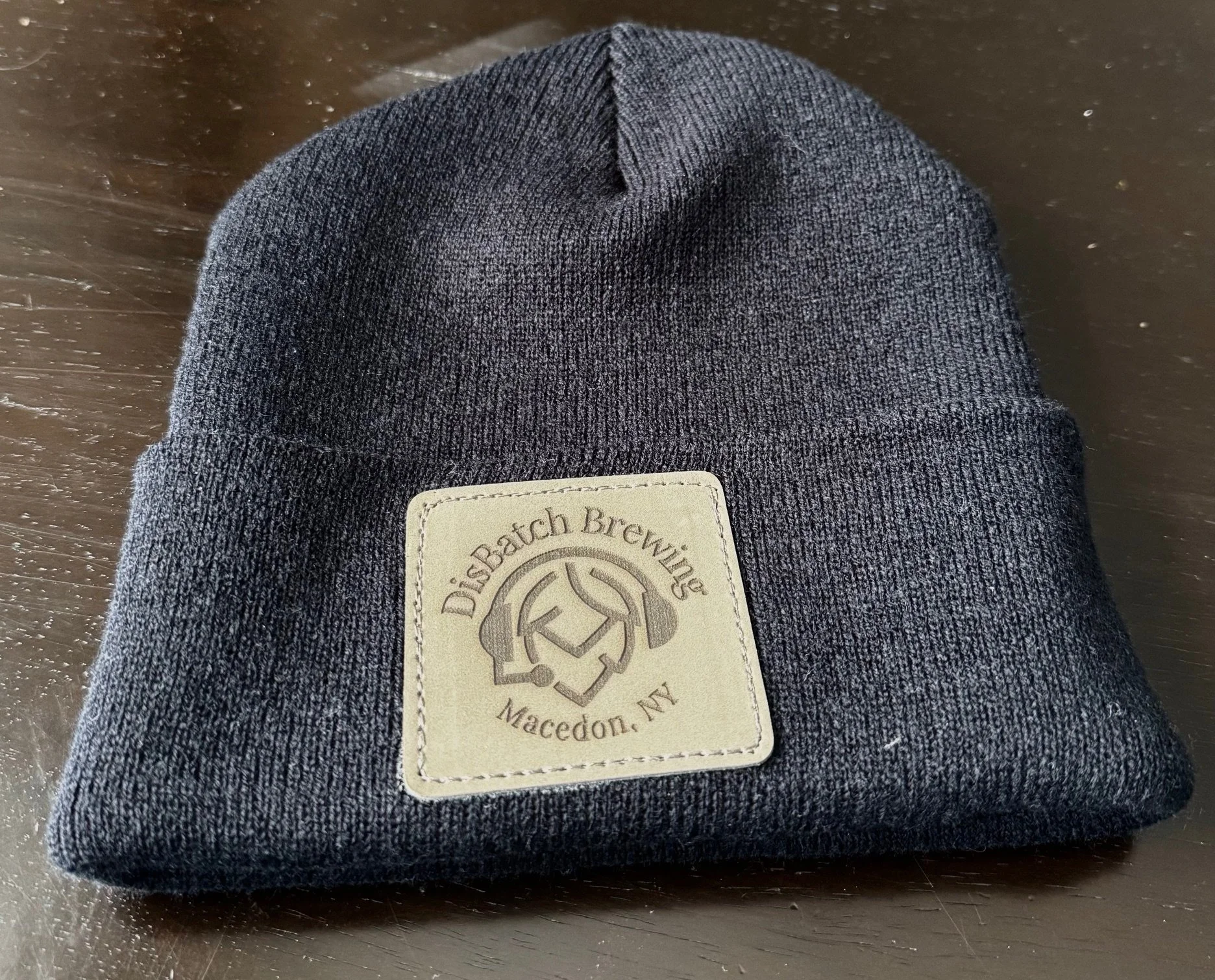 Beanie style hat with leather Disbatch Brewery patch 
