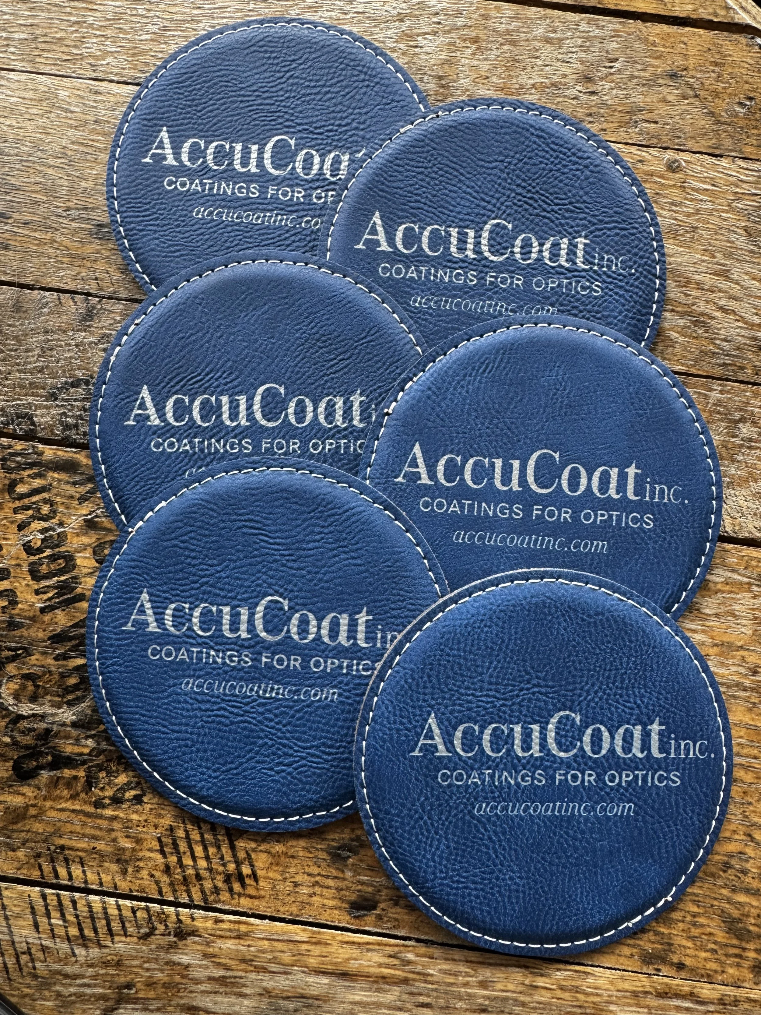 Blue leather coasters with silver engraving for AccuCoat Inc