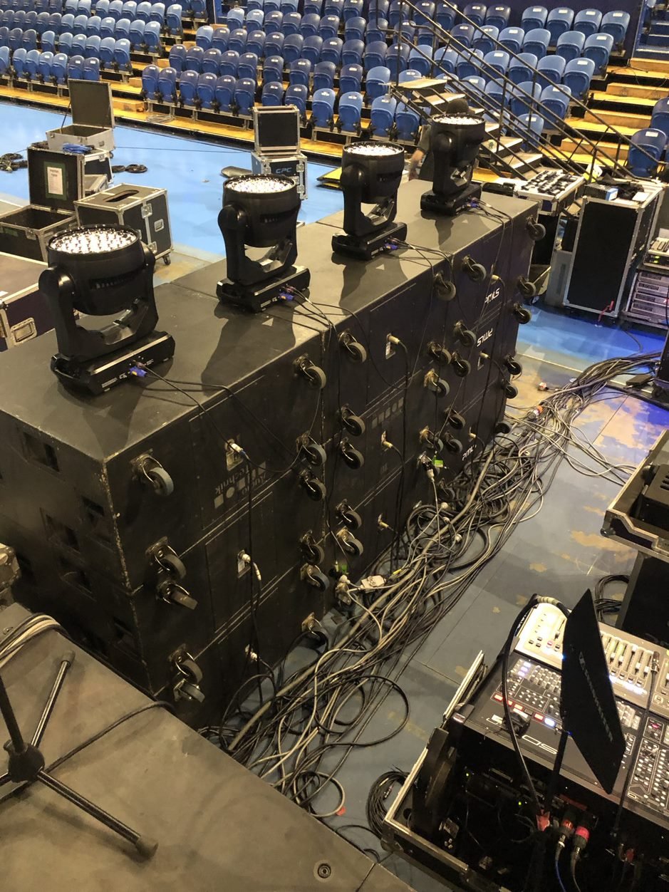 stage lighting equipment with cables and chairs in an auditorium